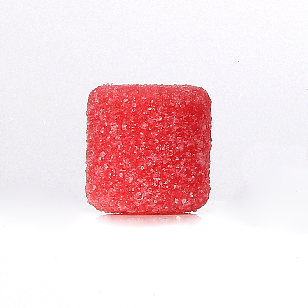Goma de creatina Pump Gummy sabor Morango sobre superfície, mostrando textura e formato mastigável
